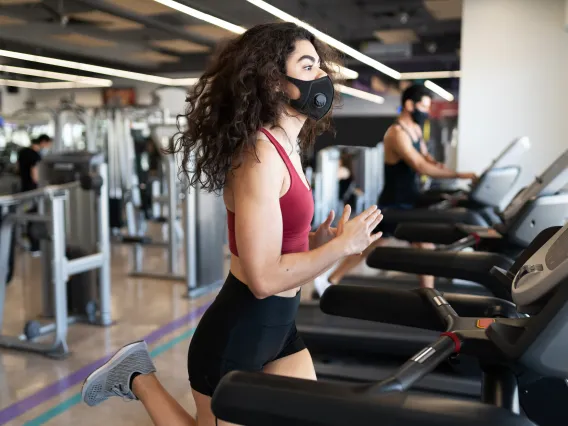 Woman exercising wearing mask