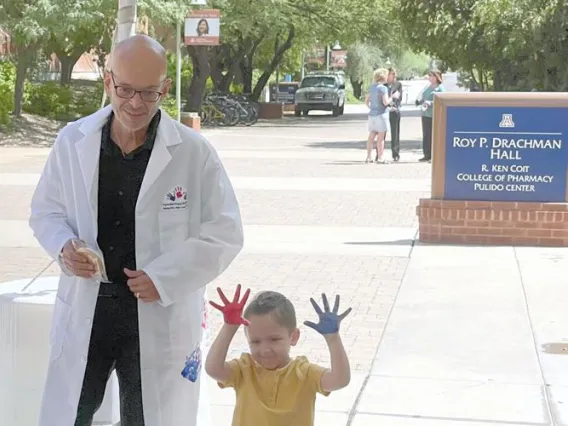 Photo of Dr. Katsanis with child